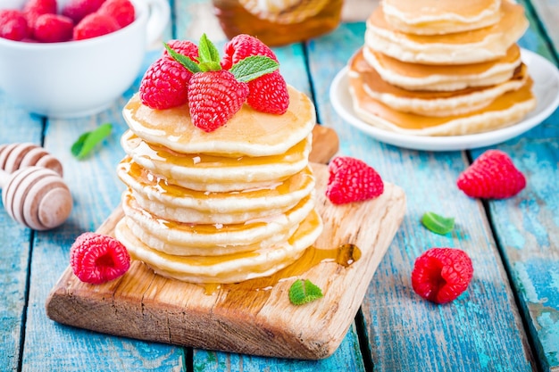 Breakfast homemade pancakes with honey and raspberry