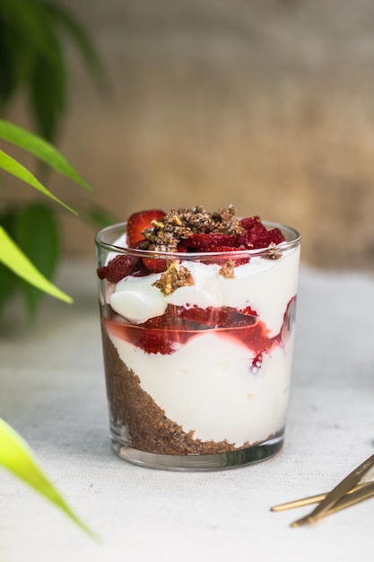 Breakfast layered parfait dessert with yogurt sponge biscuit and fresh strawberry white background copy space