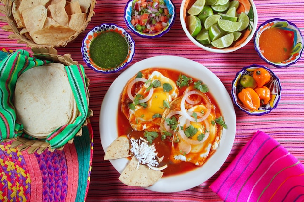 Breakfast Mexican ranchero eggs with chili and nachos