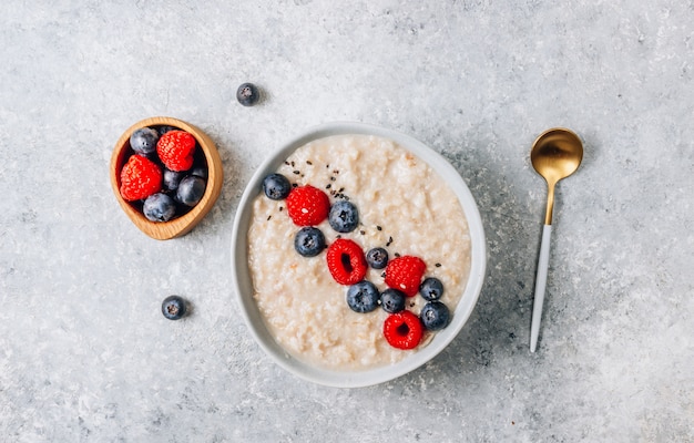 Breakfast oatmeal porridge with fresh berries and almond milk