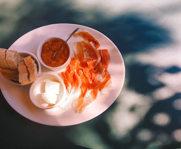 Breakfast outdoors in summer ham jam butter and ham