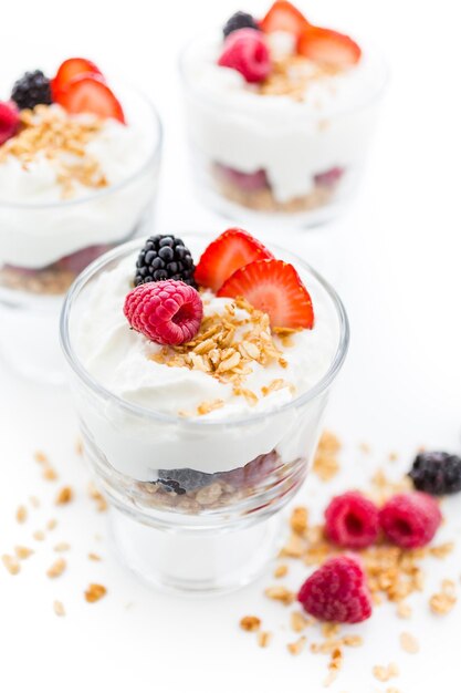 Breakfast parfait made from Greek yogurt and granola topped with fresh berries.