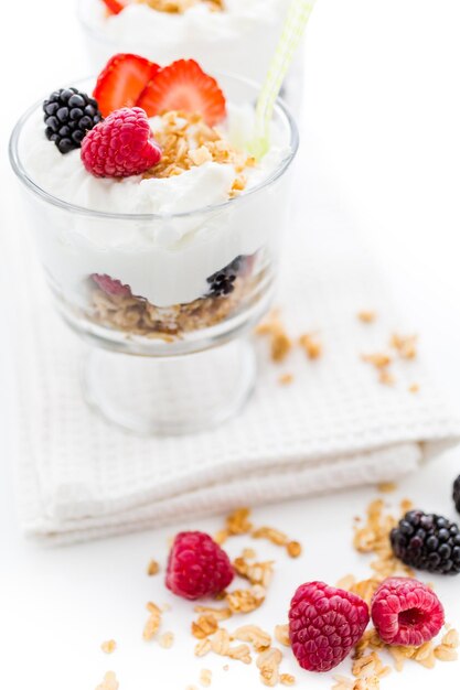 Breakfast parfait made from Greek yogurt and granola topped with fresh berries.