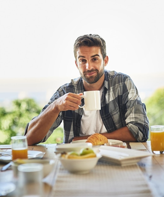 Breakfast patio and portrait of man with coffee outdoor for wellness diet and gut health balance Travel hotel or hungry person in backyard with food nutrition and croissant fruit or brunch meal