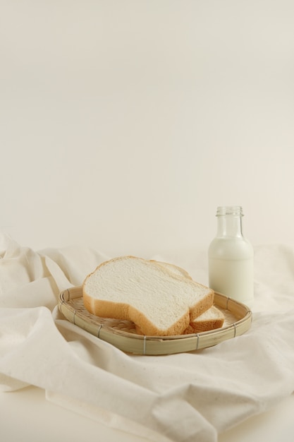 Photo breakfast set fresh milk and bread on canvas background