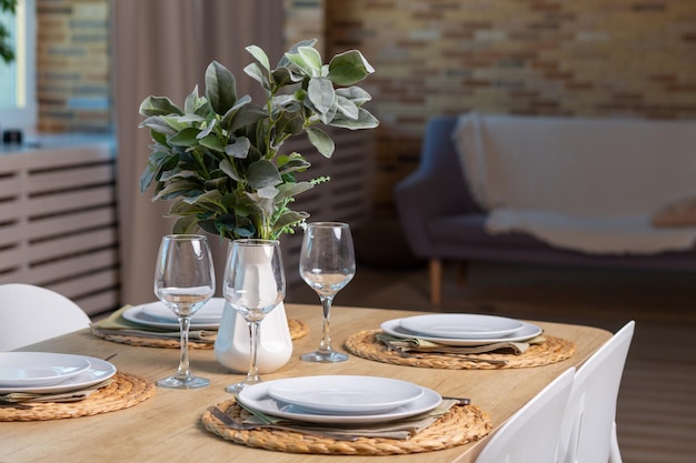 Breakfast setup on wooden table with nice vase and modern chair.