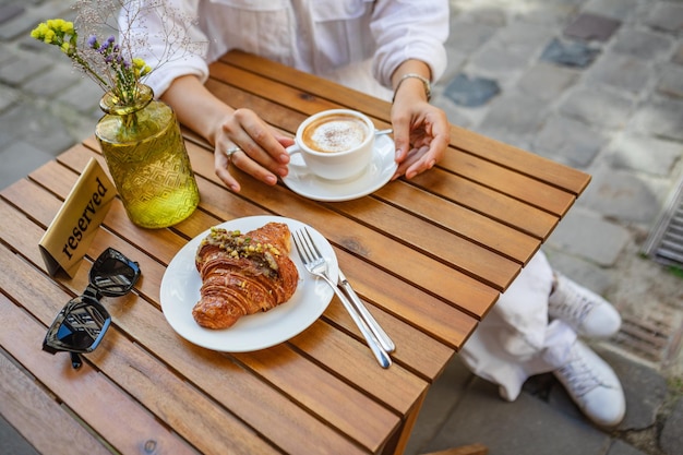 Breakfast on a summer terrace with croissants and coffee