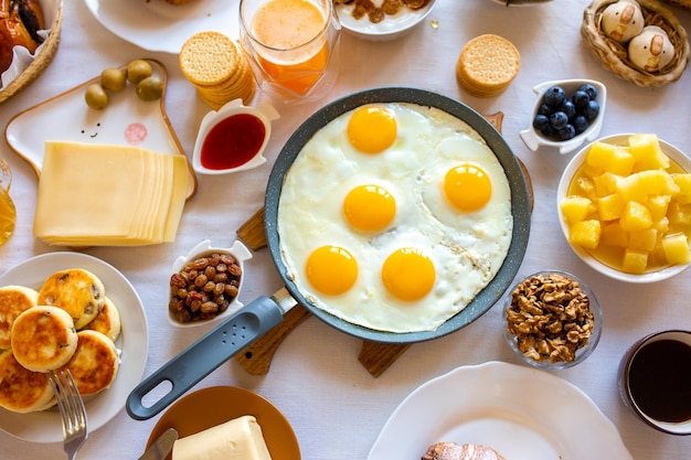 Breakfast on the table top viewFood on the table top viewMuesli with berries Fried eggsMeal day