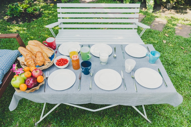 Breakfast table with food in the garden