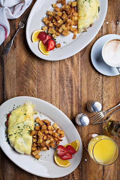 Breakfast table with omelette coffee and orange juice