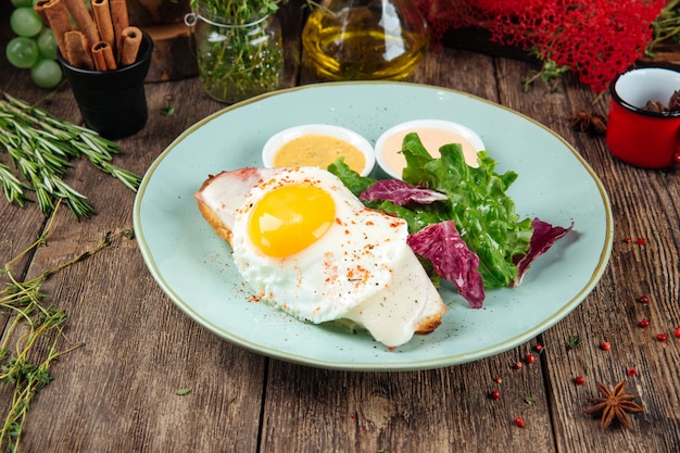 Breakfast toast with fried egg greens and sauce