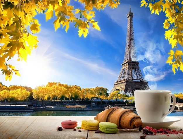 Breakfast with bakery and coffee on table near Eiffel Tower in Paris, France