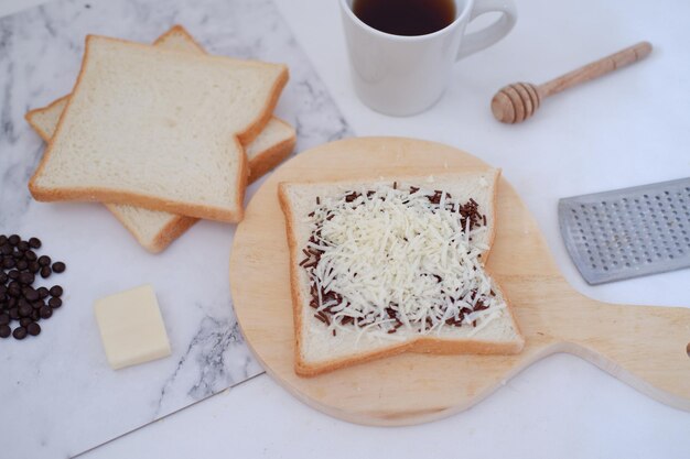 Breakfast with coffee cheese and bread on white marble table