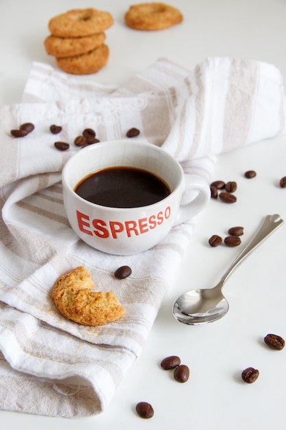 Breakfast with coffee and cookies close up on white table