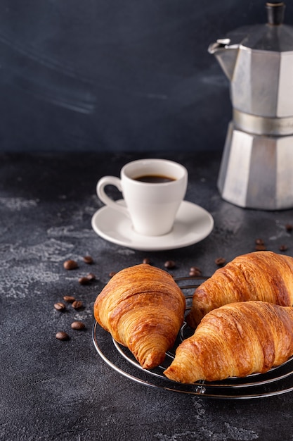 Breakfast with coffee and croissants, selective focus