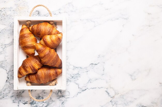 Breakfast with coffee and croissants, top view