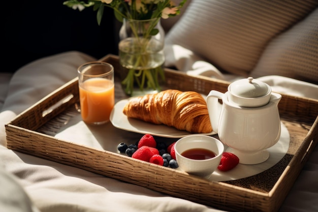 Breakfast with coffee juice croissant and fruit on a tray in bed