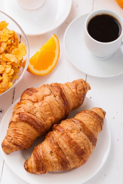 Breakfast with coffee orange juice croissant egg