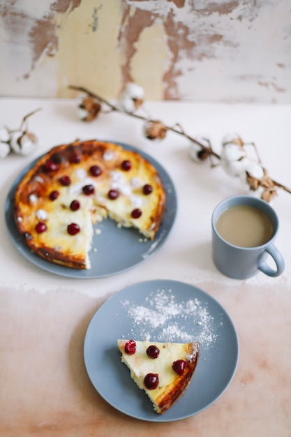 breakfast with cottage cheese casserole with berries and a cup of coffee on table top view