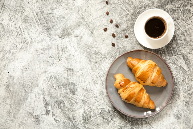 Breakfast with croissants on concrete