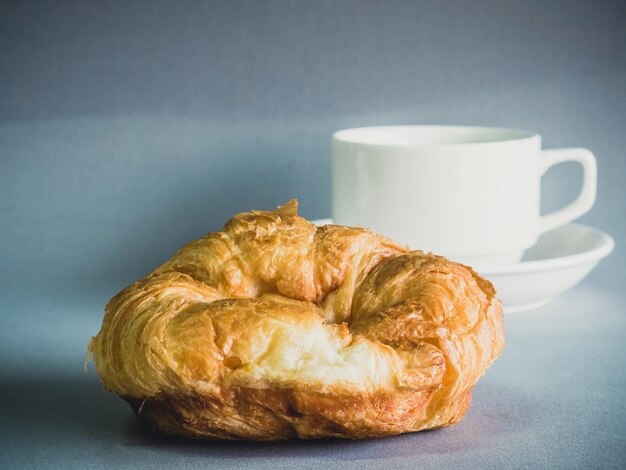 Breakfast with croissants, cup of black coffee