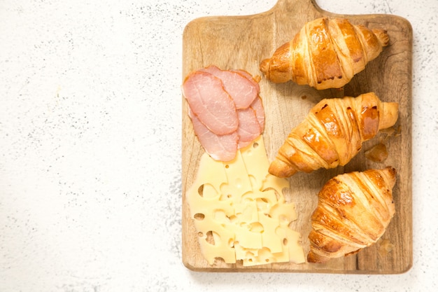 Breakfast with croissants. fresh crispy croissants and coffee, top view.