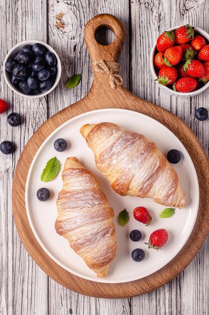 Breakfast with croissants and fresh fruits