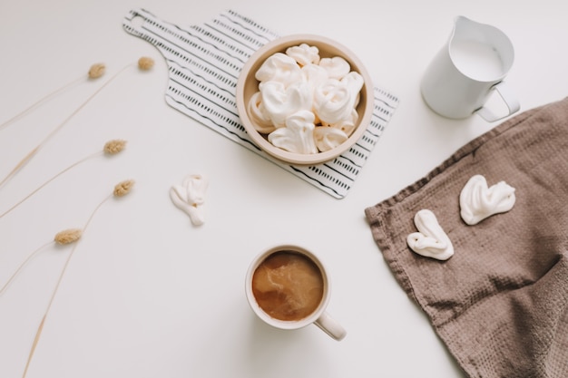 Breakfast with a cup of coffee on a white table top view flat lay