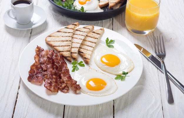 Breakfast with eggs bacon and toasts Food background