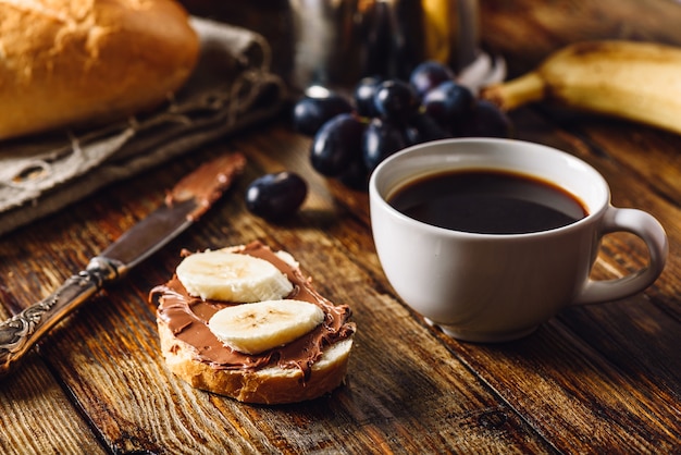 Breakfast with fruit, sandwich and coffee