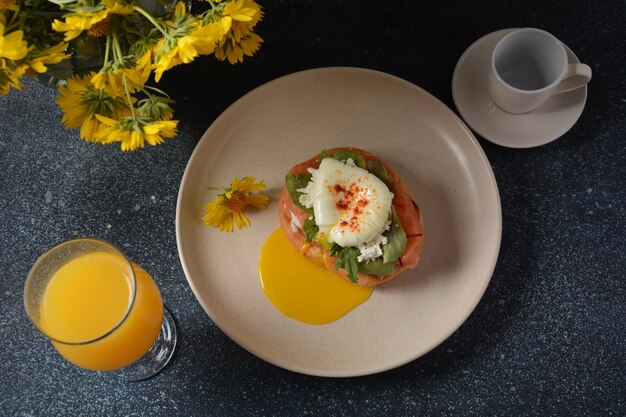 Breakfast with sandwich with cereals bread and salmon, soft cheese and poached eggs