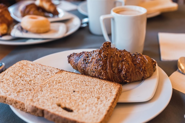 Breakfast with toast, cereal croissant and coffee. Industrial pastries.