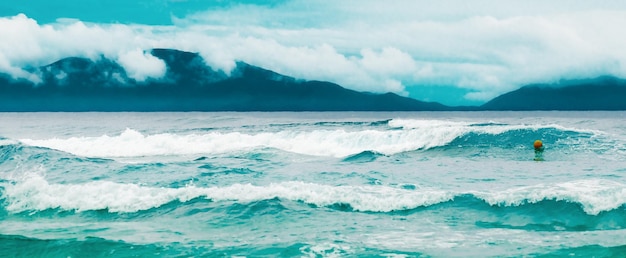 Breaking blue waves and an overcast sky