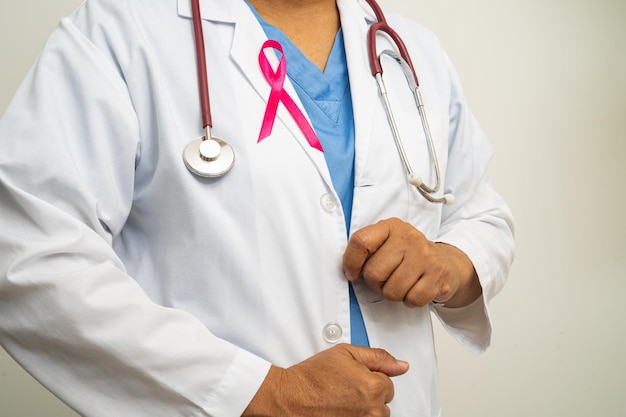 Breast cancer Asian doctor woman with pink ribbon symbol of World Breast Cancer Day