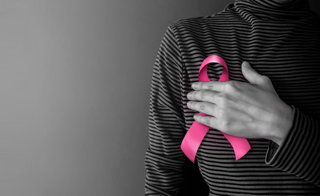 Breast Cancer Awareness Campaign Concept. Women's Healthcare. Woman Touching Pink Ribbon