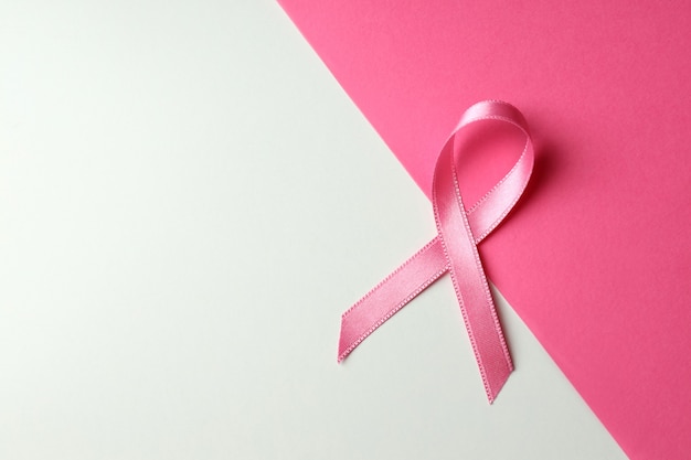 Breast cancer awareness ribbon on two tone background