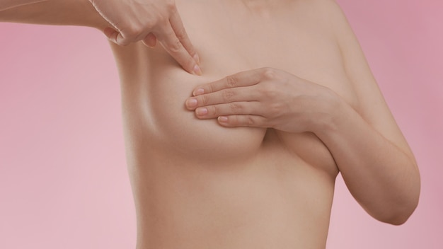 Photo breast cancer awareness. young woman doing breast self-exam (bse)