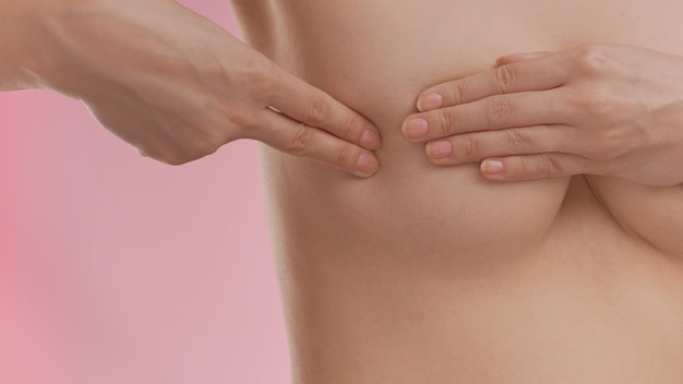 Breast cancer awareness. Young woman doing breast self-exam (BSE)