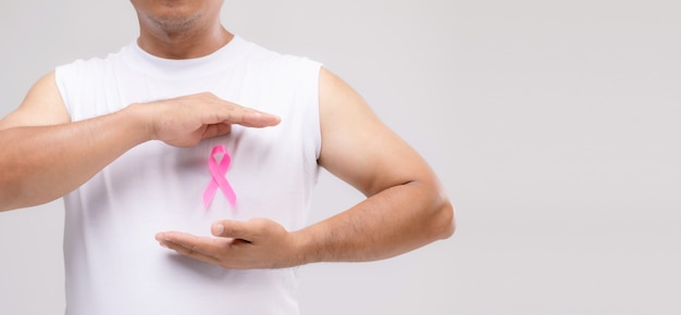 Breast cancer in men concept : Portrait Asian man and pink ribbon the symbol of breast cancer campaign. 