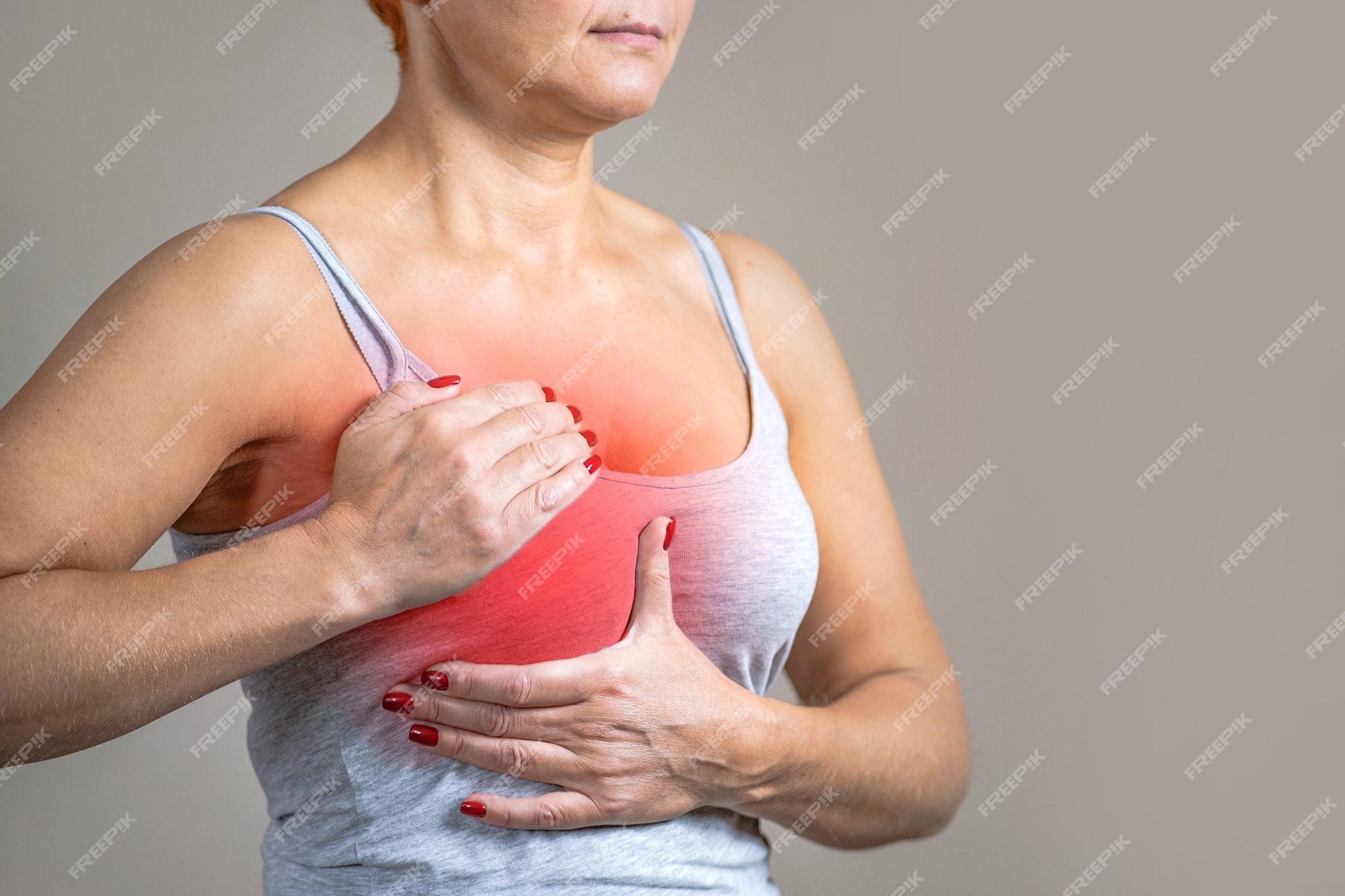 Premium Photo | Breast cancer women. the woman is holding her chest, the area of inflammation is marked in red.