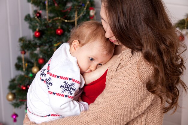 Breast feeding. Mum feeds the child.