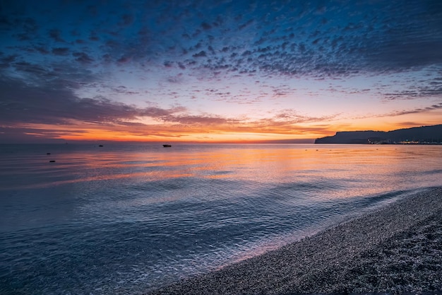 Breathtaking beauty of nature as vibrant hues paint the sky during a mesmerizing sunrise at the sea beach