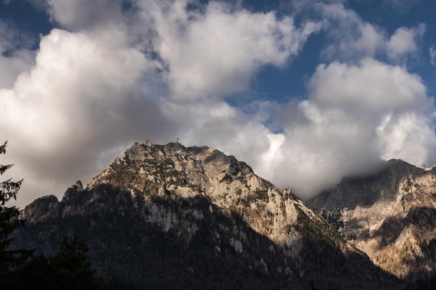 Breathtaking cloudscape over high rocky mountains on a sunny day