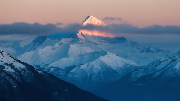 Breathtaking shot of peak of snowy alps covered by clouds