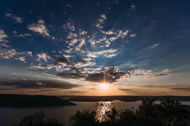 Breathtaking view of sunset on the lake with beautiful clouds and soft light