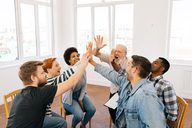 Brede opname van multiculturele en verschillende leeftijden mensen die in een cirkel zitten bij een counseling sessie