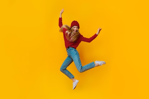Breezy girl in blue jumping in the air