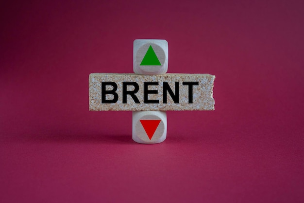 Photo brent symbol a wooden cubes with up arrow brick block with the concept word brent