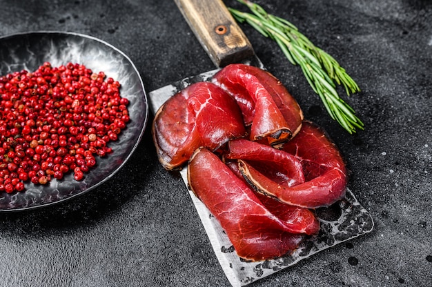 Bresaola dried beef meat sliced on a cleaver