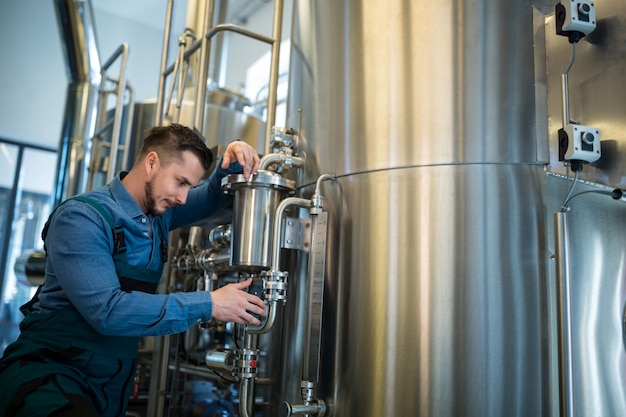 Brewer checking pressure at brewery